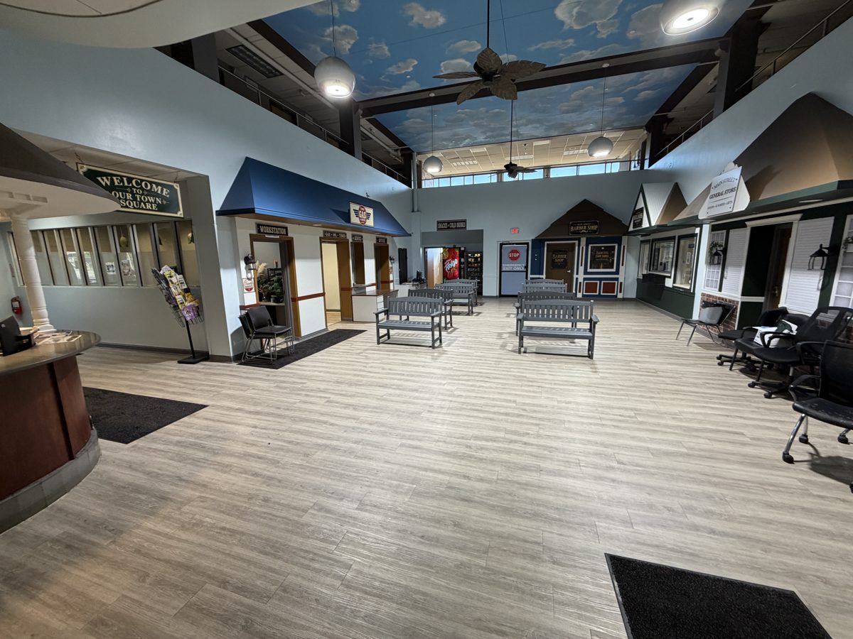 Large indoor common area with light grey wood-look plank flooring